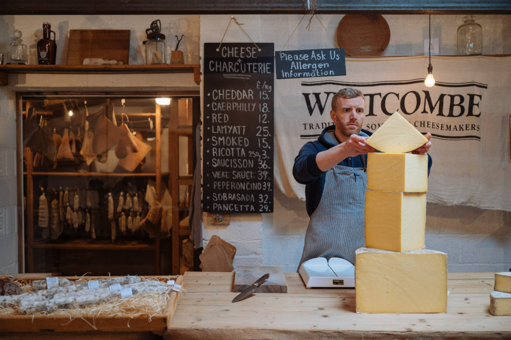Paul Burton weighs up some cheddar at Westcombe Dairy